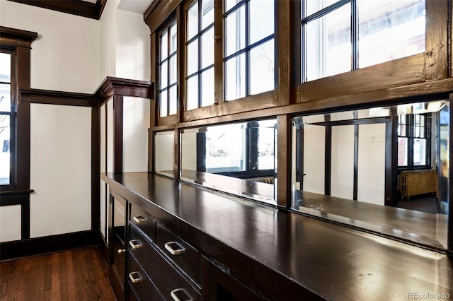 interior space featuring wood-type flooring and crown molding