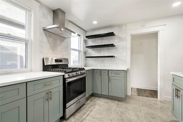 kitchen with range hood, decorative backsplash, and stainless steel range with gas stovetop