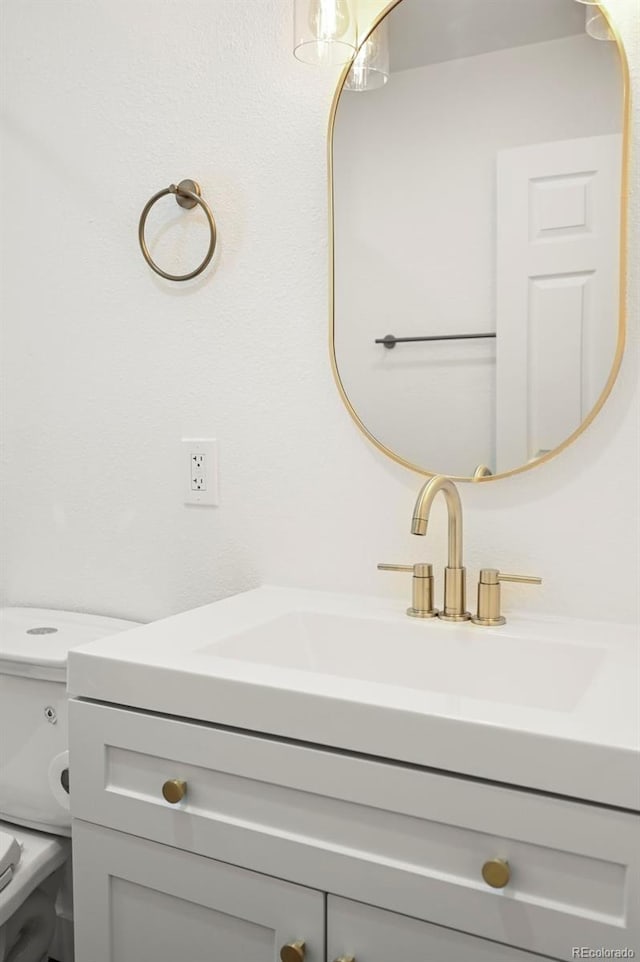 bathroom with toilet and vanity