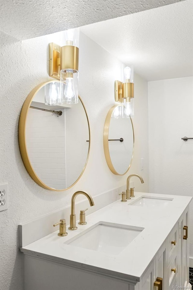 bathroom with a textured ceiling and vanity