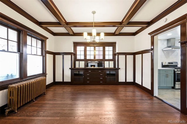 interior space with beam ceiling, radiator, and coffered ceiling