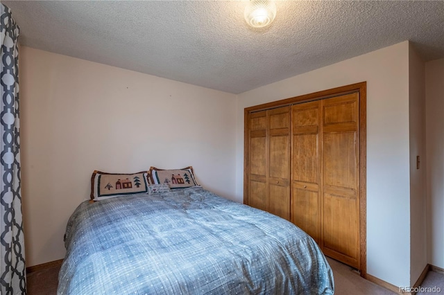 bedroom with light colored carpet, a closet, baseboards, and a textured ceiling