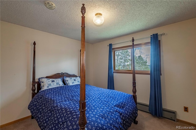 bedroom with carpet floors, a baseboard heating unit, a textured ceiling, and baseboards