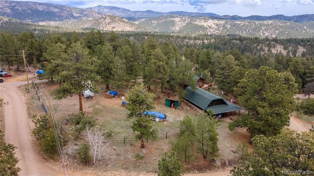 bird's eye view of a mountainous background and a heavily wooded area