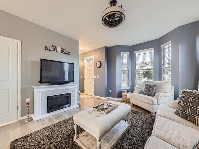 3921 E 141st Ave, Thornton, CO 80602 - living area with light wood-style floors, baseboards, and a stone fireplace