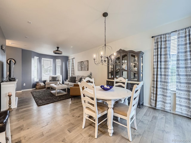 3921 E 141st Ave, Thornton, CO 80602 - dining space with a chandelier, light wood-style flooring, and baseboards