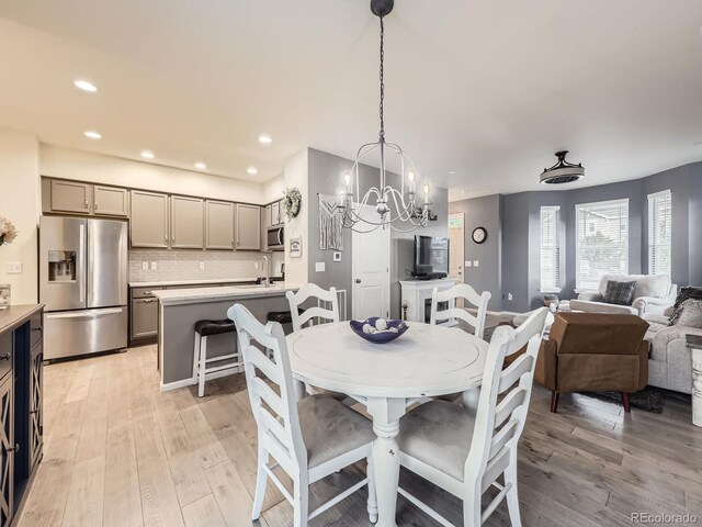 3921 E 141st Ave, Thornton, CO 80602 - dining space with a chandelier, light wood-style floors, and recessed lighting