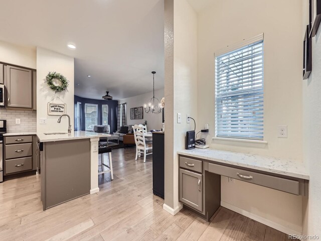 3921 E 141st Ave, Thornton, CO 80602 - kitchen with a sink, open floor plan, a breakfast bar area, healthy amount of natural light, and recessed lighting