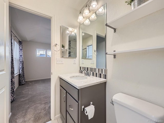 3921 E 141st Ave, Thornton, CO 80602 - bathroom featuring vanity, toilet, and baseboards