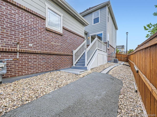 3921 E 141st Ave, Thornton, CO 80602 - view of home's exterior featuring a fenced backyard and brick siding