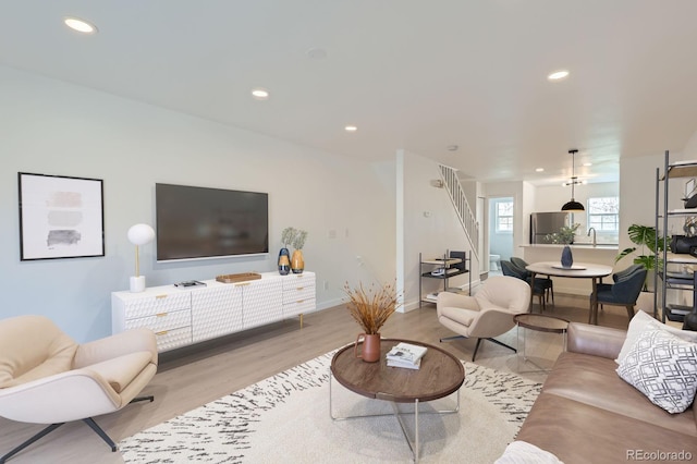 living room with baseboards, recessed lighting, and wood finished floors