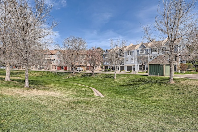 view of property's community featuring a residential view and a yard