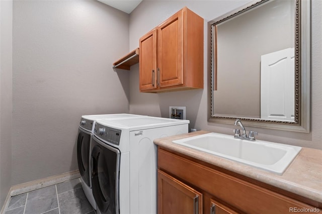 washroom with cabinet space, washer and dryer, and baseboards