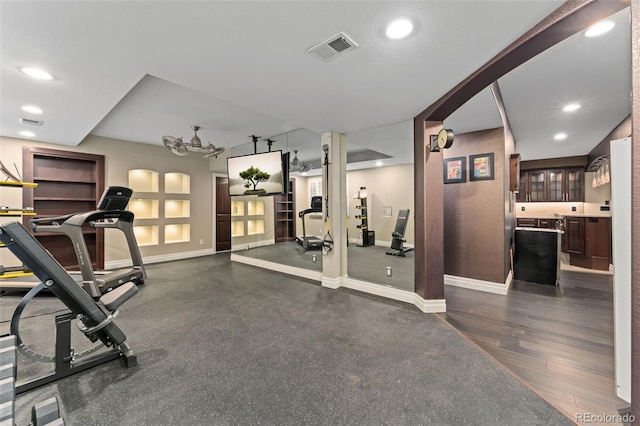 workout area featuring baseboards and recessed lighting
