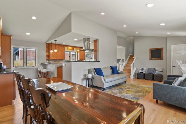 3785 E 134th Ct, Thornton, CO 80241 - dining area featuring vaulted ceiling, stairway, light wood-style flooring, and recessed lighting