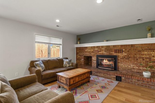 3785 E 134th Ct, Thornton, CO 80241 - living area with wood finished floors, a brick fireplace, and recessed lighting