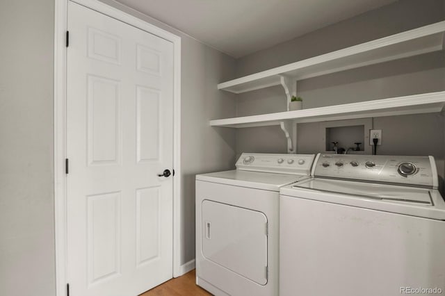 3785 E 134th Ct, Thornton, CO 80241 - laundry area featuring washing machine and clothes dryer and light wood-style flooring