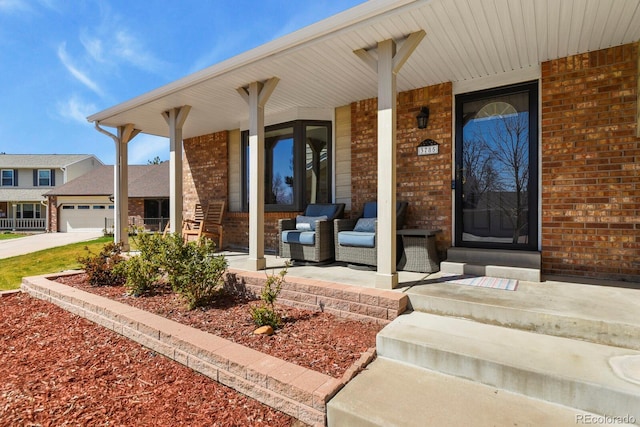 3785 E 134th Ct, Thornton, CO 80241 - view of exterior entry with a porch, brick siding, and concrete driveway