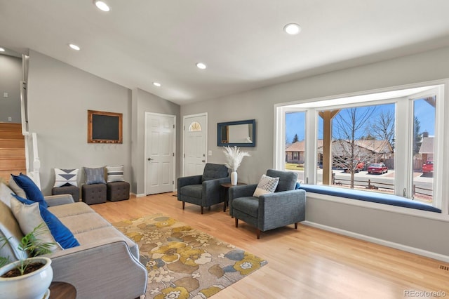 3785 E 134th Ct, Thornton, CO 80241 - living room featuring light wood finished floors, recessed lighting, vaulted ceiling, and stairs