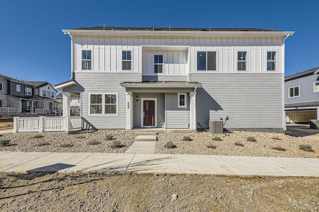 view of front of property featuring board and batten siding and central AC unit