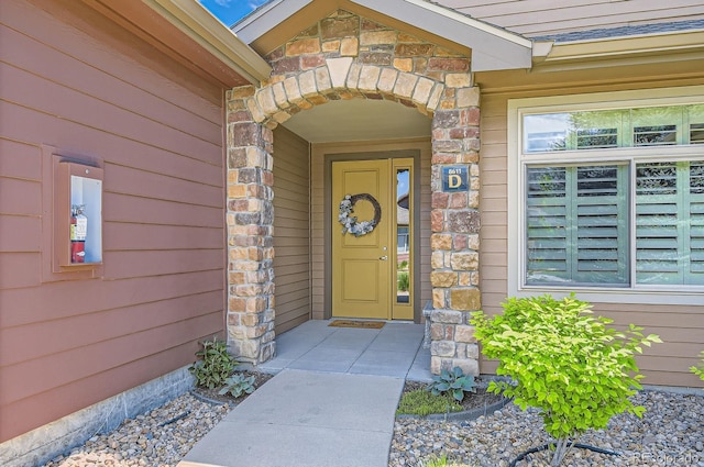 view of exterior entry featuring stone siding
