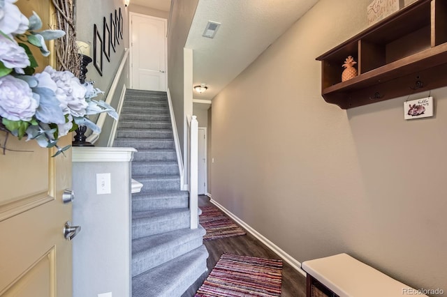 stairway featuring wood finished floors and baseboards
