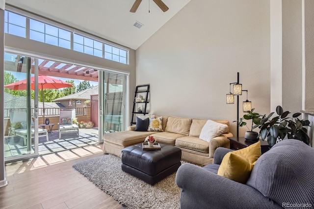 living room featuring high vaulted ceiling, wood finished floors, and ceiling fan