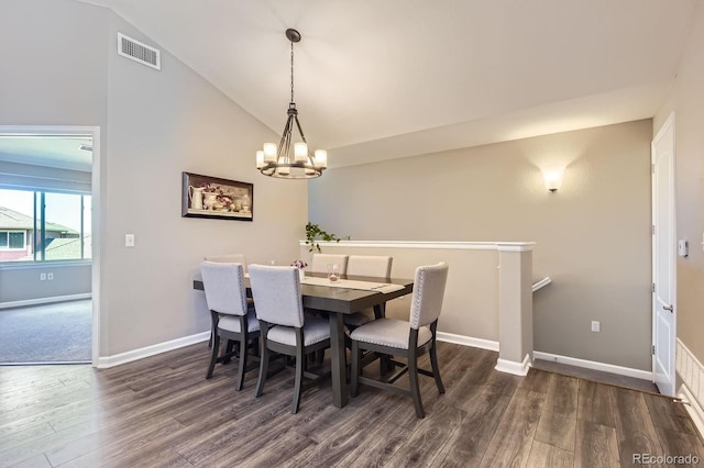 dining space featuring wood finished floors, a chandelier, baseboards, and vaulted ceiling