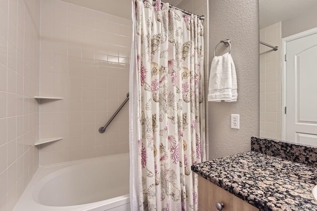 full bathroom with a textured wall and shower / bath combo