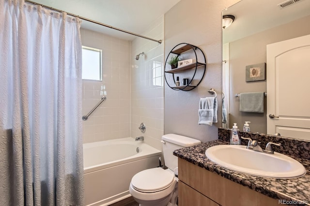 bathroom with shower / bath combo with shower curtain, toilet, and vanity