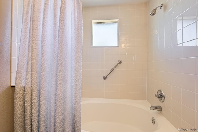 bathroom with shower / bath combination with curtain