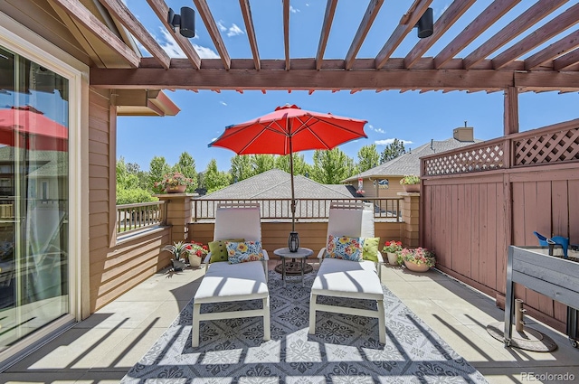 view of patio with a pergola and fence