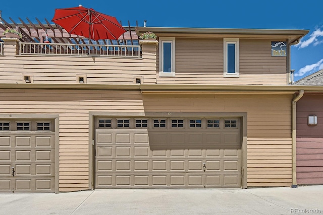 garage featuring concrete driveway