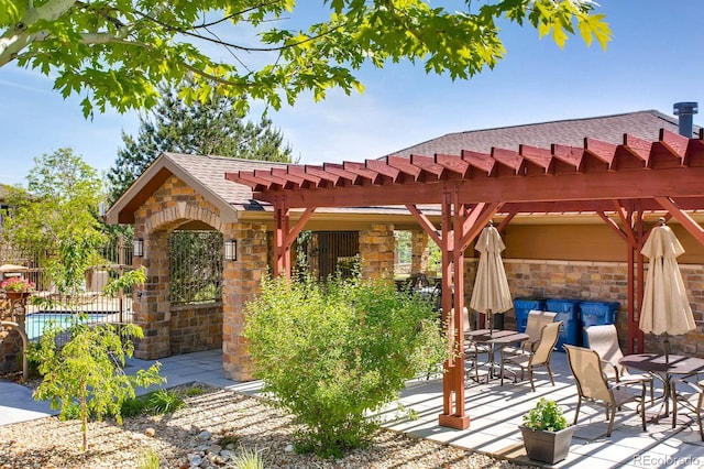 view of patio / terrace with outdoor dining space, a pergola, and fence