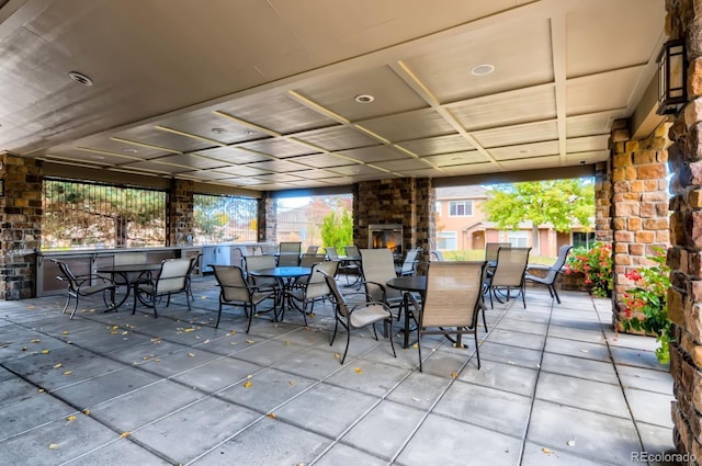 view of patio / terrace with outdoor dining area and a large fireplace