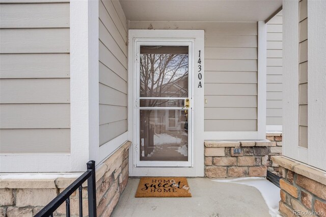 entrance to property featuring stone siding