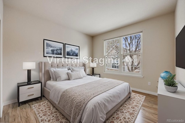 bedroom with baseboards and light wood-style floors