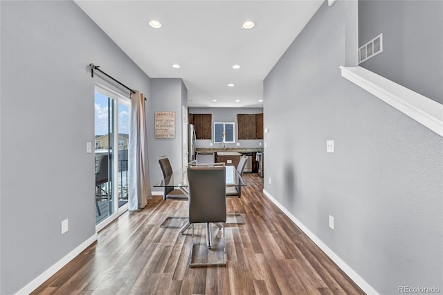 dining room featuring sink and dark hardwood / wood-style floors