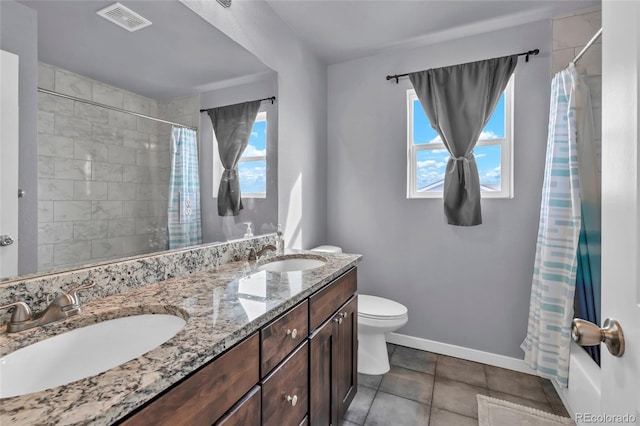 bathroom with walk in shower, tile patterned floors, vanity, and toilet