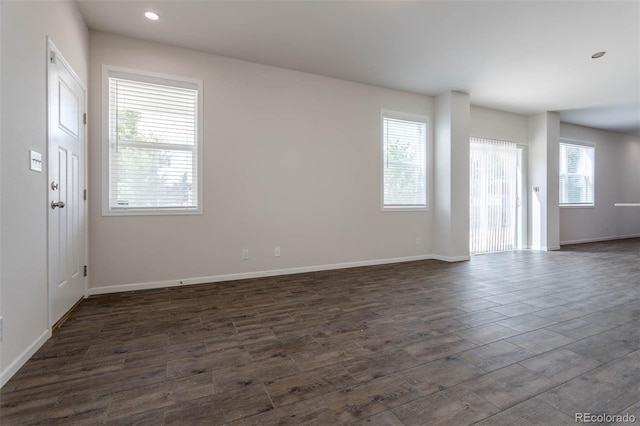 spare room featuring dark wood-type flooring