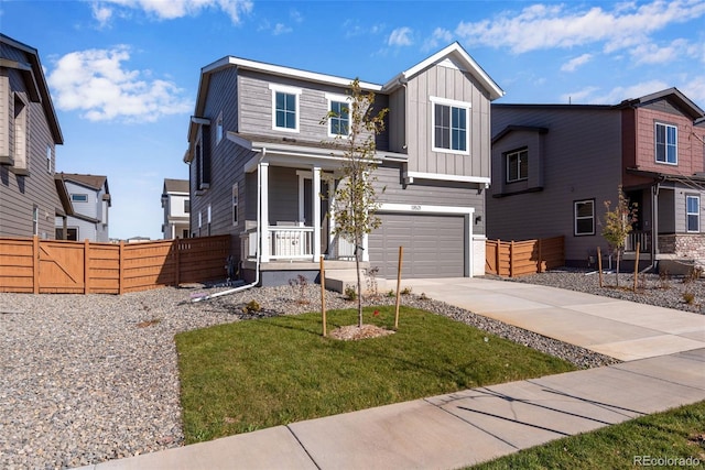 view of front of house featuring board and batten siding, concrete driveway, a garage, and covered porch