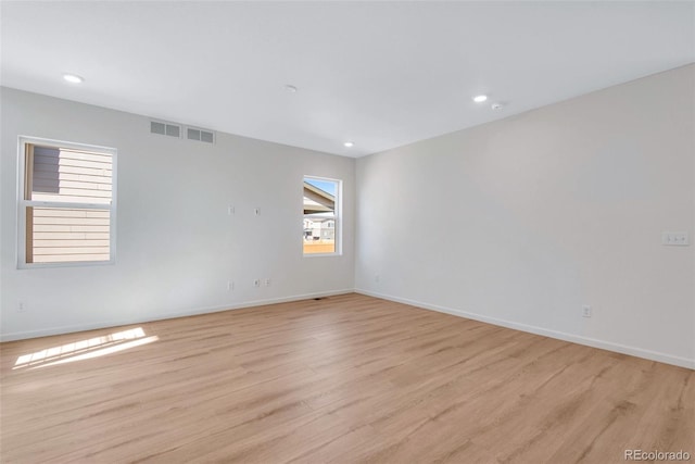 empty room with light hardwood / wood-style floors