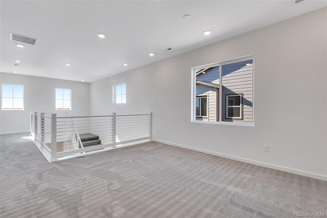 carpeted empty room with baseboards and recessed lighting