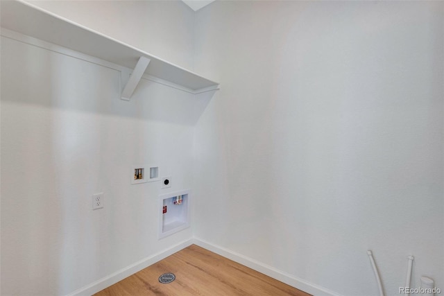 clothes washing area with hookup for a washing machine, hardwood / wood-style flooring, and hookup for an electric dryer