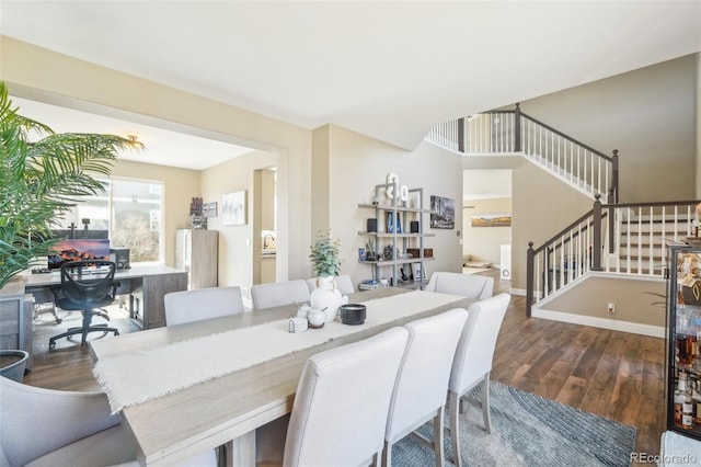 dining room featuring stairway, baseboards, and wood finished floors