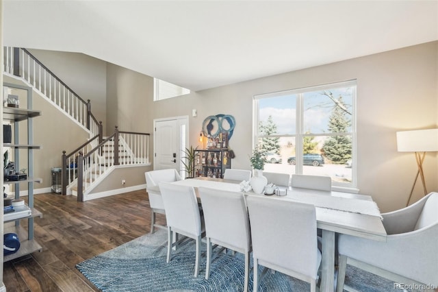 dining room featuring baseboards, dark wood-style flooring, and stairs