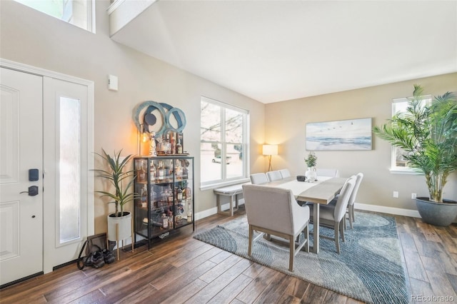 dining room with dark wood finished floors and baseboards