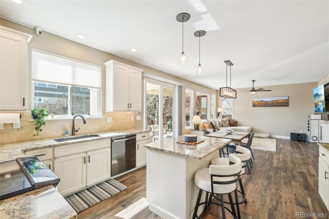 kitchen featuring stainless steel dishwasher, decorative backsplash, dark wood-style flooring, and a sink