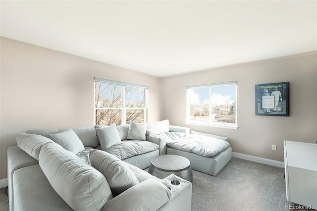 living room featuring a healthy amount of sunlight, baseboards, and carpet