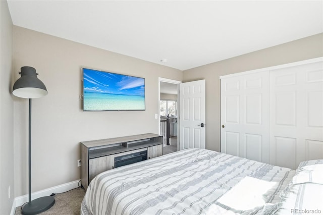 bedroom with a closet, baseboards, and carpet